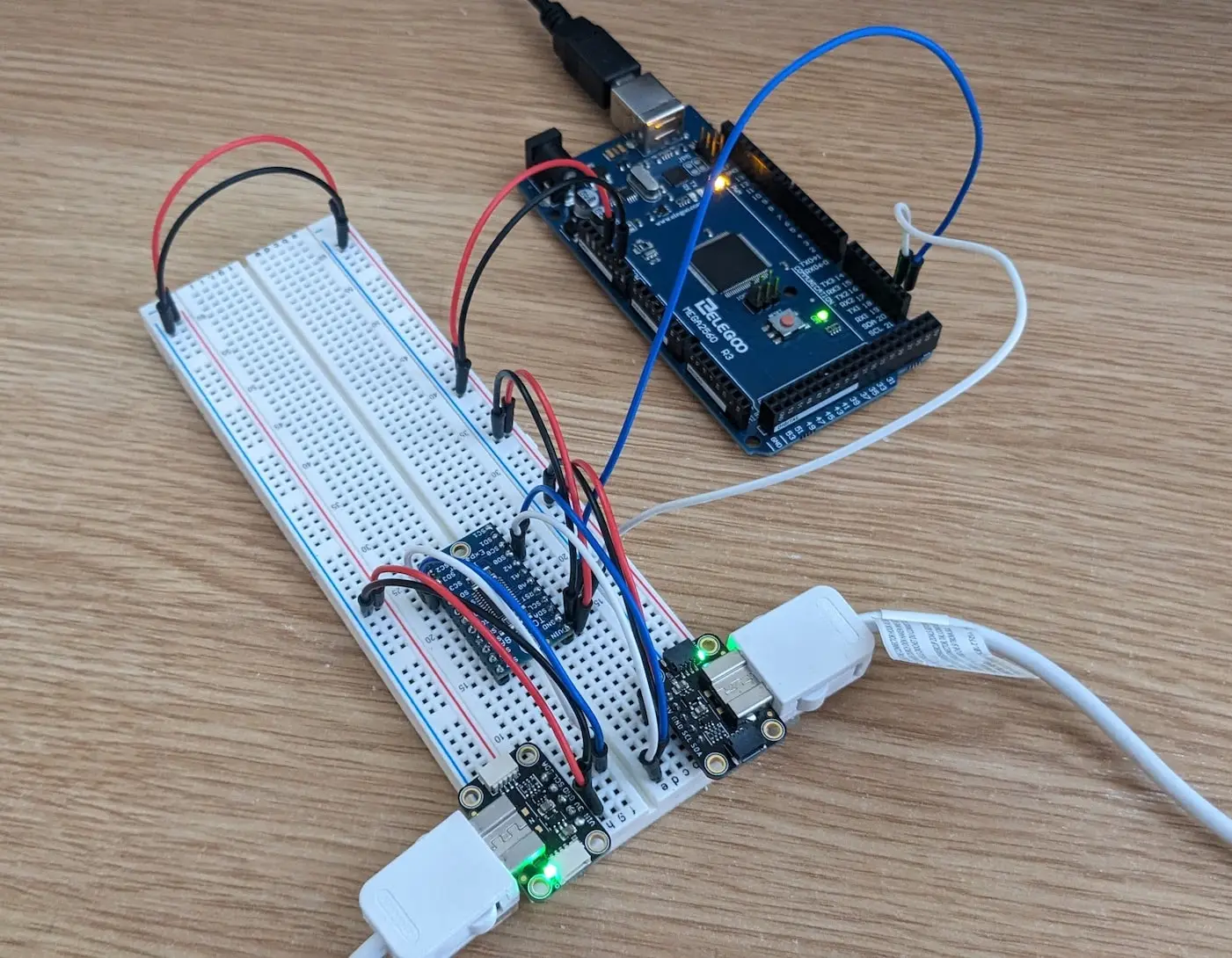 A breadboard wired up to an Arduino microcontroller and attached to two Nintendo nunchuck controllers through an adapter.